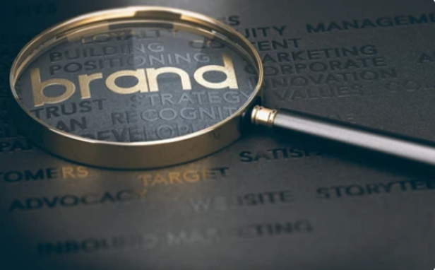 A magnifying glass over the words brand highlighting  the benefits of a company branded onboarding system