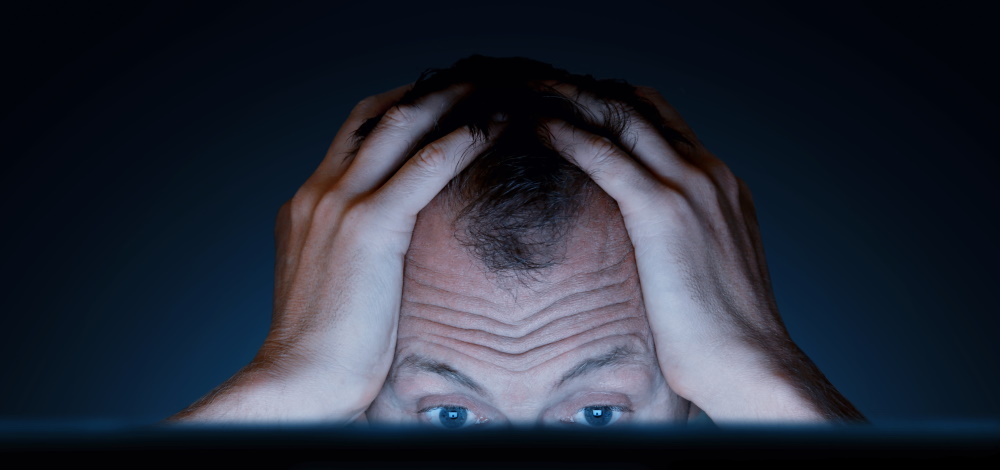 Male lawyer holding his head in frustration in choosing the right  e-signature provider
